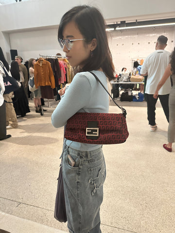 Photo showing the customer with a red handbag in the pop up event