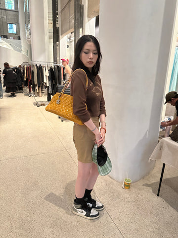 Photo showing the customer with an yellow handbag in the pop up event