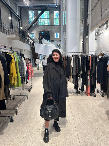 Photo showing the store owner with a black handbag  in the pop up event