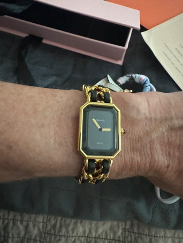 Photo showing the customer tried on the Chanel watch that she purchased.